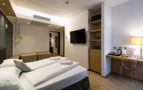 a hotel room with a bed and a desk at Boutique Exclusive B&B in Trento
