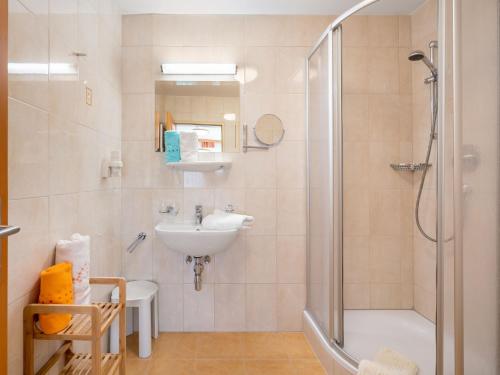 a bathroom with a sink and a shower at Apartment Rosa-6 by Interhome in Mayrhofen
