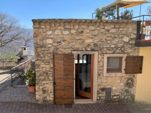 a stone building with a door and a window at Holiday Home Casa Susanne by Interhome in Spiazzi Di Caprino