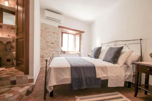 a bedroom with a bed and a brick wall at Casa Ijana in Novigrad Istria