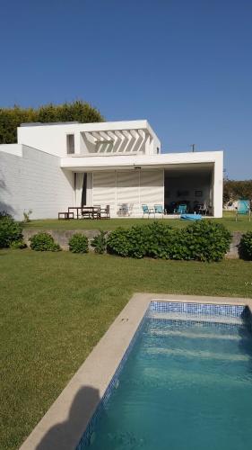 a house with a swimming pool in front of a house at Casa de Gião in Gião
