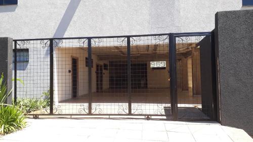 a gate with an open door to a building at STUDIO CENTRAL IV in Cascavel