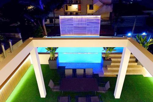 a view of a pool at night with lights at Swiss House 5 in Pattaya South