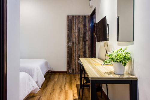 a bedroom with a table with a plant on it at Surprised Homestay Butterworth in Butterworth