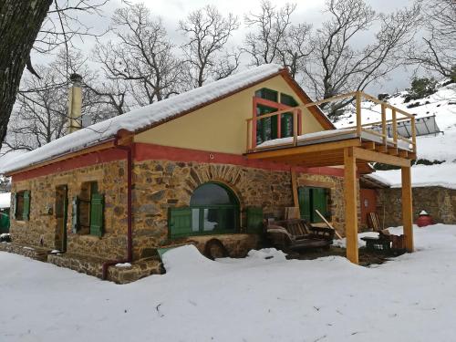 a small house with snow on the roof at Hani Kastania - Chania retreat for families and groups for holidays and workshops in Sémbronas