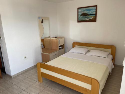 a small bedroom with a bed in a room at Apartments Top of Budva in Budva