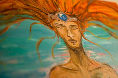 a painting of a woman with orange hair at Apartment MERAN in Mariánské Lázně