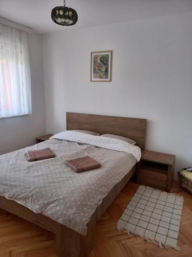 a bedroom with a bed with two pillows on it at Apartman Bregovi in Trebinje