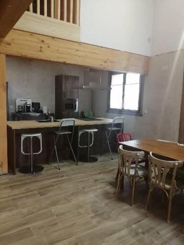 a kitchen with a table and chairs in a room at Casa rural Lastoetxe in Larrauri