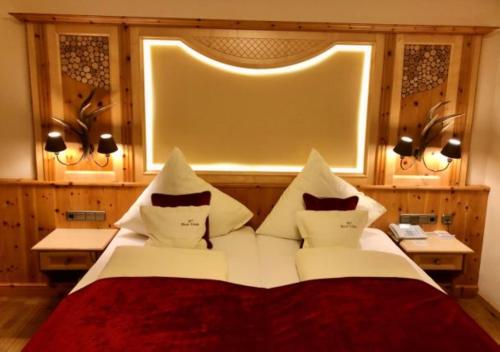 a bedroom with a bed with pillows and a window at Ortner's Resort in Bad Füssing