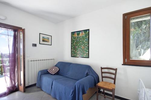 a room with a blue bed and a chair at Monolocale Fattorialmare Viola in Camogli