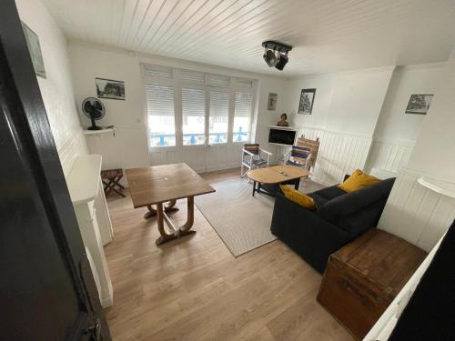 a living room with a couch and a table at Le typique touquetois, 55m² hypercentre in Le Touquet-Paris-Plage