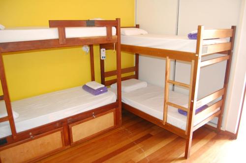 a room with three bunk beds in a room at MADÁ hostel in Sao Paulo