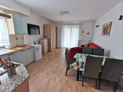 a kitchen and a living room with a table and chairs at Apartments Novigrad in Novigrad Istria