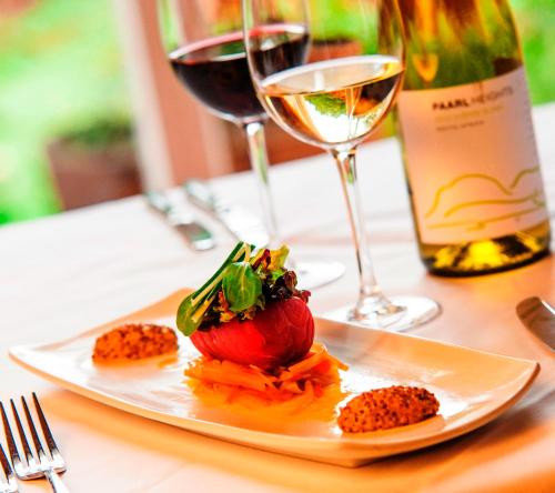a plate of food on a table with wine glasses at Coul House Hotel in Contin