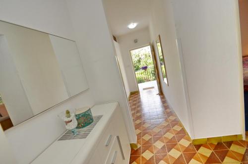 a kitchen with a white counter and a hallway at Apartments Corovic in Kotor