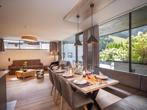 a dining room with a long table and chairs at Apartment Top1 by Interhome in Zell am See