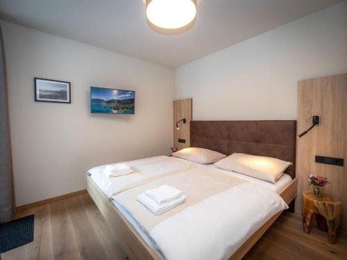 a bedroom with a large bed with two towels on it at Apartment Top1 by Interhome in Zell am See