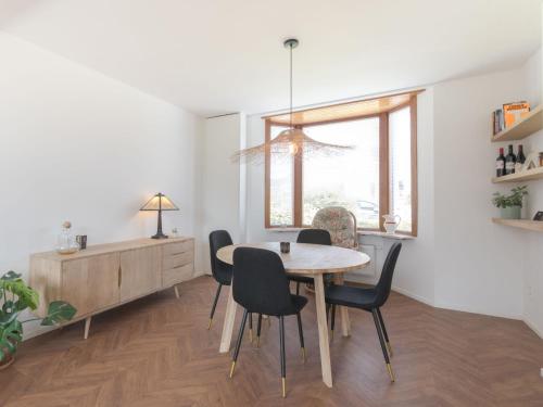 a dining room with a table and chairs at Villa Hutje bij de Zee by Interhome in Bredene