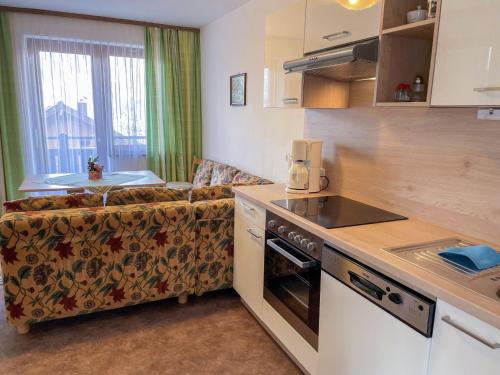 a living room with a couch and a kitchen at Apartment Oberberghof by Interhome in Uttendorf