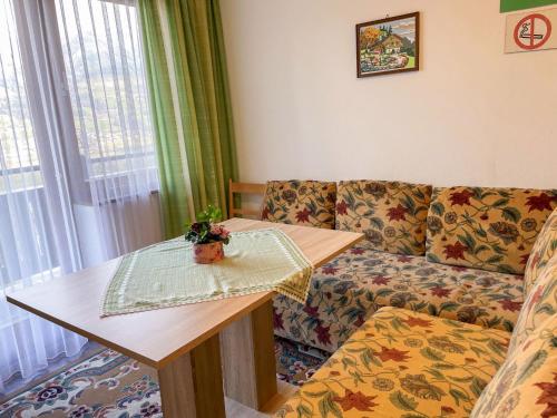 a living room with a couch and a table at Apartment Oberberghof by Interhome in Uttendorf