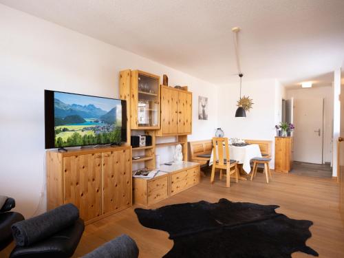 ein Wohnzimmer mit einem TV und einem Esszimmer in der Unterkunft Apartment Chesa Corvatsch 211 - Champfer by Interhome in Champfer