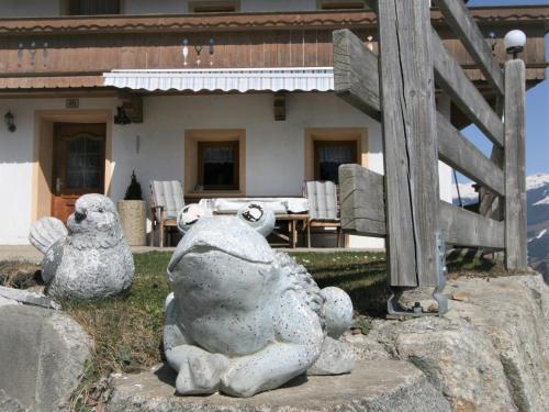 a statue of two stuffed animals sitting on a rock at Holiday Home Ferienhaus Lamplberg by Interhome in Hippach