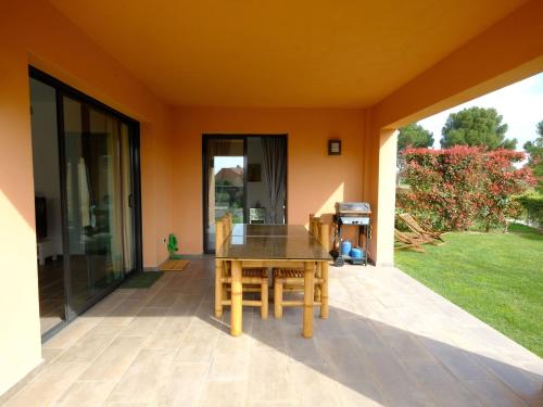 a patio with a wooden table and chairs at Apartment Rabassades by Interhome in Montroig