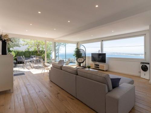 a large living room with a couch and a television at Holiday Home Pitágoras by Interhome in Roses