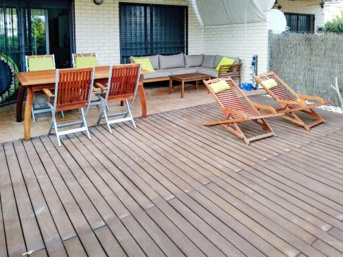 a patio with chairs and a table and a couch at Apartment Vila del Far by Interhome in Sant Carles de la Ràpita