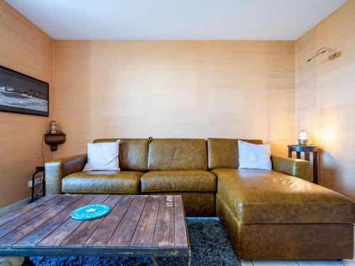 a living room with a couch and a coffee table at Apartment Er Palouen by Interhome in Quiberon