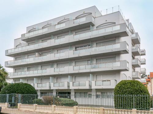 a white building with balconies on it at Studio Jetée des Marins-5 by Interhome in Arcachon