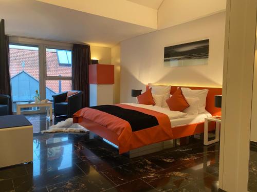 a hotel room with a bed and a desk and window at TRIP INN Kaiser Hotel & Restaurant Heidelberg-Schriesheim in Schriesheim