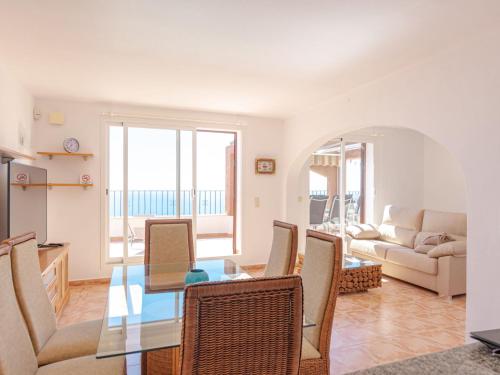a living room with a glass table and chairs at Apartment Azul Celeste by Interhome in Benitachell