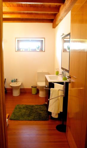 a bathroom with a sink and a toilet at Casa de Reborido in Ponte da Barca