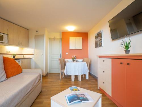 Ce petit appartement comprend une table et une cuisine. dans l'établissement Apartment Le Belvédère - D4 257 by Interhome, à Agay