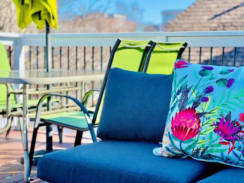a blue chair with a pillow on a patio at The Loft at Charlotte's Rose in Charlottetown