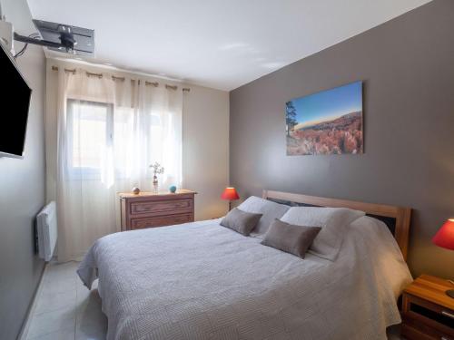 une chambre avec un grand lit et une fenêtre dans l'établissement Apartment Le Giono by Interhome, à Saint-Laurent-du-Var