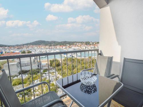 a balcony with a table and chairs and a view of a city at Apartment Anna-3 by Interhome in Jezera