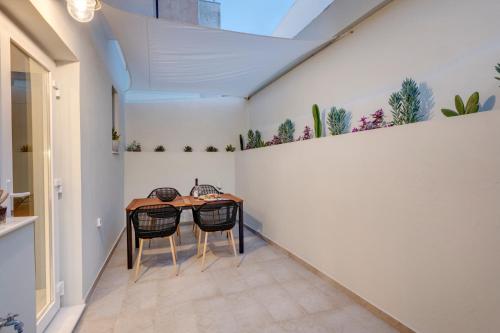 a dining room with a table and two chairs at Polis Suite in Ermoupoli