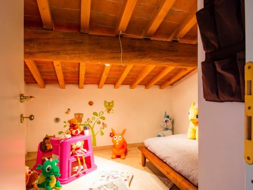 a bedroom with a bed and stuffed animals in it at Holiday Home Mulini by Interhome in Pugnano