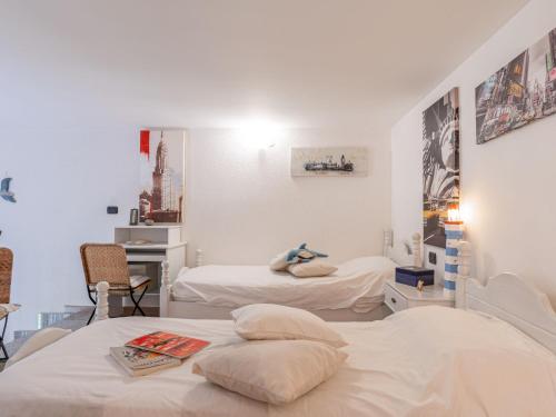 a hospital room with two beds and a desk at Apartment Vista Mare by Interhome in Latte
