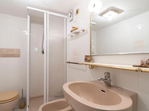 a bathroom with a sink and a toilet and a shower at Apartment Vista Mare by Interhome in Latte