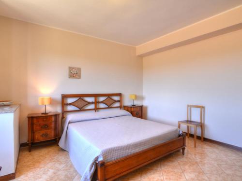 a bedroom with a large bed and two night stands at Villa Smeraldo by Interhome in Siracusa