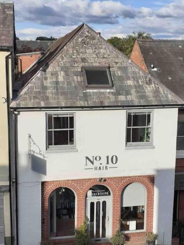 a white building with the words no man on it at The Old Fire Station Ludlow in Ludlow