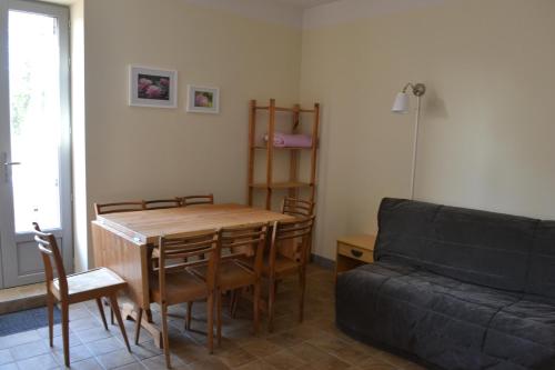 a living room with a table and a couch at Domaine de Peyreguilhot in Laparade