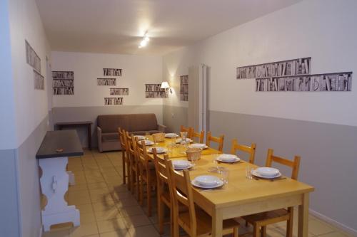 a dining room with a long table and chairs at Domaine de Peyreguilhot in Laparade