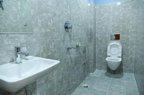 a bathroom with a sink and a toilet at SILVER REGENCY in Guwahati
