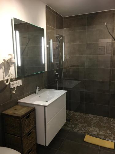 a bathroom with a sink and a shower and a mirror at Haus Greet in Muhr