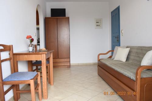 a living room with a couch and a table at Asterias Studios in Agia Anna Naxos